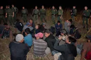 McAllen, Texas, USA: The large group awaits transportation by the side of the road.