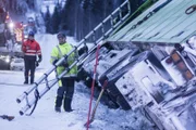 Overhalla, Norway - (Left to Right) Ole Henrik Blengsli and Tor Arne Øyen in action. Tor Arne is carrying a ladder and wants to use it to get on the top of the truck to attach the wire.