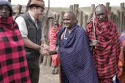 Josh shakes hands with Maasai Chief Batnoti Tipileit outside the Maasai village in Tanzania, Africa.