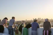 The group enjoys the view of Los Angeles from the balcony.