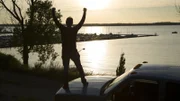 Glenn on top of truck at sunset - CU.