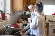 Centennial Park, AZ: Rose Cawley and her daughter help clean the kitchen before family breakfast time. (Photo credit: Elise Kirk/ National Geographic Channels)