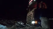 Odda, Norway - The truck that needs help is attached to a wire to get help on the slippery road.