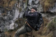 Josh Gates strapped to a zip line over a gorge outside of Mittenwald, Germany.