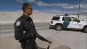 Nogales, AZ: An armed official at the border. Drug cartels have increased the violence along the border, so Customs and Border Protection agents are prepared to encounter dangerous situations.