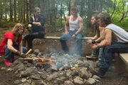 Bear Brown, Noah Brown, Gabe Brown, Bam Bam Brown and Matt Brown sitting around a campfire discussing who will skipper the Integrity.