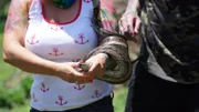 Durban, South Africa - Simon Keys and Siouxsie Gillett, with Siouxsie holding a juvenile African rock python (Python sebae).