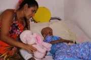 Magally Gonzalez Sierra (known as Magally) lying in bed with her mother SofÍa Sierra Diaz (known as Sofia Sierra) beside her.