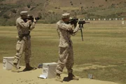 M27 Gun - US Marines taking fire standing.