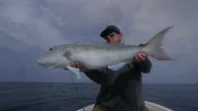 Chris poses with a Job Fish he caught in Papua New Guinea.