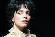Patrizia glares.