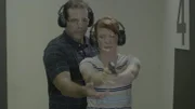 A man trains a woman to shoot