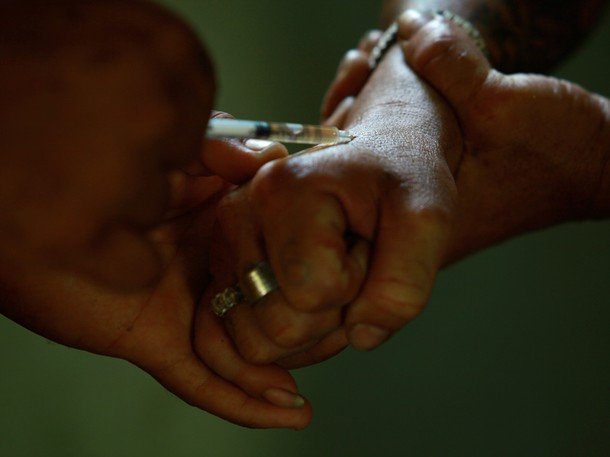 Heroin being injected into an addict's hand