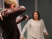 Shane points gun at a terrified Cheryl.