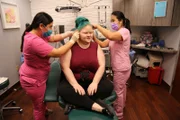 Dr. Sandra Lee and Medical Assistant Val clean up Jennifer's ears after surgery.