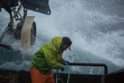 Engineer Tirey Cordrey braces himself as a rogue wave slams into the Brenna A.