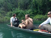 Behind the scenes of Kacie and Aaron in a boat with the crew in Belize.