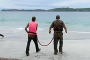 Caesar and Blake walk over snowy terrain.