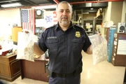 New York City, NY, USA: Boris Sapozhnikov from CBP holding up two bags of molly in the JFK Mail facility.