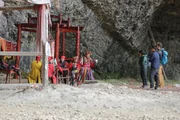 NINGQIANG COUNTY, HANZHONG CITY, SHAANXI PROVINCE, CHINA - (Left to Right) He Zongfa, the master of water ceremony performing the ritual to bless Abond & Ben with safe travels into the cave. The ethnic minority, Qiang, holds this ceremony to remove evil and disaster, as well as bring good luck.