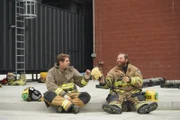 Tory and Tommy sit in their trainee uniform