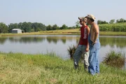 JT and Tim standing by lake.