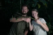 Forrest Galante and Cortni Bergerson smile while holding a Parson's chameleon.