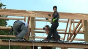 Gabe, Rain, and Bear Brown building barn.