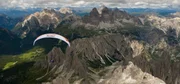 Athlete flying Cross country from the turnpoint Tre Cime at the Red Bull X-Alps in Italy on the 21th of july 2011