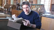 Dr. Michael Scott with Henry of Grosmont manuscript, Cambridge