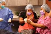 Anthony's daughters examine their father's lipoma.