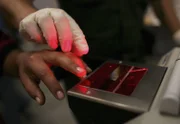 NOGALES, AZ :  A woman gets her fingerprints taken after she was caught crossing the U.S. border with Mexico illegally, at the U.S. Border Patrol processing center June 21, 2006 in Nogales, Arizona.