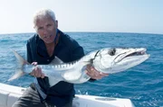 Jeremy Wade holding a barracuda in the Florida Keys, Miami.