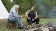 Billy and Noah Brown at a campfire.