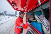 Overhalla, Norway - Roar Skjeflo (one of Jo Roger´s employees) picks up a strap to help the truck in the ditch.