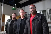 Mike Bara, Chad Jenkins and Leland Melvin stand with their safety goggles on before the experiment begins at the Carnegie Institute.