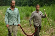 A candid shot of the two trudging through a field.