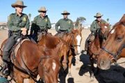 SAN DIEGO, CA, USA: Border patrol agents on horseback survey the area surrounding the San Ysidro port, the boundary separating San Diego from Tijuana. While these agents travel by horse, others work on foot, by car or ATV, or by helicopter to provide holistic coverage.