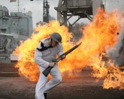 REENACTMENT: American Serviceman running through harbor whilst under attack.