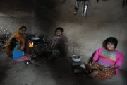 Amisha, Yogita and Harsh Nandwana sitting on the floor with their mother Pragnaben Nandwana.