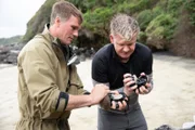 New Zealand - Zane (L), a local fisherman, teaches Gordon Ramsay how to open pāua, one of the ocean's greatest delicacies.