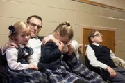 Carol Thompson's husband and children at the hospital where Carol has died.