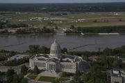 Medium shot of the Missouri state capitol with the Missouri River in the background, in Jefferson City
