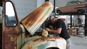 Joe and the crew check under the hood of the milk truck to get the International running.