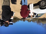 Rathbun and Sobek interact in front of a car.