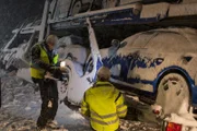 FINNSNES, Norway - Camera operator Magnus Wiig filming Frank Sebulonsen, as he prepares to rescue a truck transporting nine cars. (Photo Credit: National Geographic Channels)