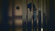 Corey Davis is behind bars looking down.