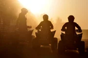 SAN DIEGO, CA, USA: At sunset, a group of border patrol agents on ATVs survey the international boundary that separates San Diego from Tijuana. This San Ysidro border crossing is the busiest in the world, with over 40 million people entering the U.S. through this port in 2005 alone.

(Photo Credit: © NGT)