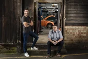 Mike Brewer and Marc 'Elvis' Priestley at the Wheeler Dealers Dream Car garage with the Beetle inside the workshop.