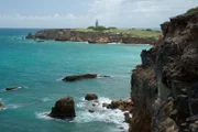 Cabo Rojo, Puerto Rico, USA: Overlooking the Carribean Sea from the limestone cliffs on the southwestern tip of Puerto Rico, with Cabo Rojo Lighthouse in the distance.